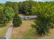 Gray house with large yard and wooded area, seen from above at 1142 Harbins Rd, Dacula, GA 30019