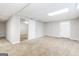 Unfinished basement with neutral carpeting and exterior access at 7325 Czar Pl, Riverdale, GA 30296