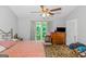 Spacious bedroom with large window and ceiling fan at 825 S Bethany Rd, Locust Grove, GA 30248
