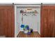Well-lit laundry room with washer, dryer, and barn-style doors at 825 S Bethany Rd, Locust Grove, GA 30248