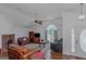 Living room with hardwood floors, vaulted ceiling, and a brick fireplace at 825 S Bethany Rd, Locust Grove, GA 30248