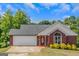Brick ranch house with a two-car garage and well-maintained landscaping at 825 S Bethany Rd, Locust Grove, GA 30248