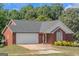Brick ranch house with a two-car garage and neatly landscaped yard at 825 S Bethany Rd, Locust Grove, GA 30248