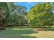 Spacious backyard with lush green grass and mature trees at 825 S Bethany Rd, Locust Grove, GA 30248