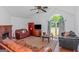 Living room featuring hardwood floors, vaulted ceiling, and a brick fireplace at 825 S Bethany Rd, Locust Grove, GA 30248