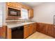 Kitchen with wood cabinets, dishwasher, and microwave at 602 Pine Tree Trl, College Park, GA 30349