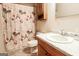 Clean bathroom with a shower/tub combo and wood vanity at 140 Grove Creek Dr, Locust Grove, GA 30248