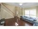 Bright living room featuring hardwood floors and an open staircase at 1231 Hillview Rd, Hampton, GA 30228