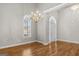 Bright dining room featuring hardwood floors, chandelier, and arched windows at 65 Northwood Springs Dr, Oxford, GA 30054