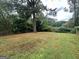 Large backyard with grassy area and mature trees at 2311 Amber Way, Decatur, GA 30032