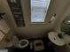 Small bathroom with white sink and toilet; gray floor at 844 Venture Sw Way, Atlanta, GA 30331