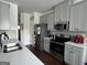 Modern kitchen with gray cabinets, stainless steel appliances, and white countertops at 844 Venture Sw Way, Atlanta, GA 30331