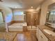 Bathroom featuring a soaking tub, walk-in shower, and granite vanity at 1656 Woodbridge Ne Ln, Atlanta, GA 30329