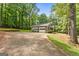 Ranch home with attached two-car garage and long driveway, nestled in a wooded setting at 50 Ridgeview Dr, Jonesboro, GA 30236