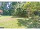 Landscaped backyard with arbor and wooden fence at 3142 Brooks Dr, Snellville, GA 30078