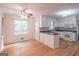 Open kitchen with breakfast bar and hardwood floors at 3142 Brooks Dr, Snellville, GA 30078
