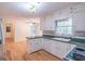 Kitchen features white cabinets, green countertops, and a dishwasher at 3142 Brooks Dr, Snellville, GA 30078