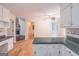 Spacious kitchen with white cabinets and a view into living room at 3142 Brooks Dr, Snellville, GA 30078