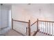 Upstairs hallway with wood railing and access to bedrooms at 3142 Brooks Dr, Snellville, GA 30078