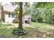 House back view with large tree and screened porch at 235 Ashley Forest Dr, Fayetteville, GA 30214