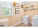 Convenient laundry room with washer, dryer, and overhead shelving at 235 Ashley Forest Dr, Fayetteville, GA 30214