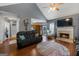 Living room with hardwood floors, fireplace and view into kitchen at 130 Cornus Dr, Covington, GA 30016