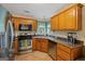 Kitchen boasts stainless steel appliances and wood cabinets at 130 Cornus Dr, Covington, GA 30016