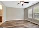 Bedroom with hardwood floors, ceiling fan, and access to a bathroom at 173 Mulberry Ct, Peachtree City, GA 30269