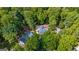 Aerial view of house nestled in woods; large lot with ample green space at 109 Rosewood Ct, Peachtree City, GA 30269