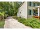 Side view of a house showcasing green siding and a partially visible driveway at 109 Rosewood Ct, Peachtree City, GA 30269