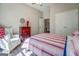 Well-lit bedroom with a striped comforter and an armchair at 2 Poplar St, Porterdale, GA 30070