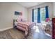 Bright bedroom featuring a metal bed frame and large window at 2 Poplar St, Porterdale, GA 30070