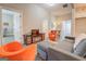 Open living room with grey couch, orange chairs, and hardwood floors at 2 Poplar St, Porterdale, GA 30070