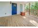 Front porch with blue door and wooden flooring at 2 Poplar St, Porterdale, GA 30070