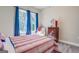 Cozy bedroom with a striped comforter and a view from the window at 2 Poplar St, Porterdale, GA 30070