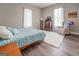 Bedroom with wooden bed frame, white rug, and dresser at 2 Poplar St, Porterdale, GA 30070