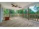 Spacious front porch with wooden flooring and railing at 2 Poplar St, Porterdale, GA 30070