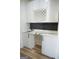 Modern wet bar with white cabinetry and wine rack at 3419 Hamilton Ave, Hapeville, GA 30354