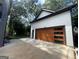 Modern garage with wood accent door and ample parking space at 3419 Hamilton Ave, Hapeville, GA 30354