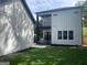 Modern home with white siding, a second-story deck and grassy yard at 3419 Hamilton Ave, Hapeville, GA 30354