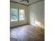 Spacious bedroom with hardwood floors and large windows at 3419 Hamilton Ave, Hapeville, GA 30354