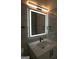 Modern bathroom with an illuminated mirror and quartz countertop at 3419 Hamilton Ave, Hapeville, GA 30354