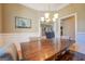 Bright dining room with a large farmhouse table and view into the living room at 1483 Woodlawn Rd, Covington, GA 30014