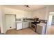 Galley kitchen with white cabinets, stainless steel appliances, and mosaic backsplash at 164 Glenloch Pkwy, Stockbridge, GA 30281