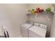 Laundry room with washer, dryer, and shelving at 1461 Hada Ln, Lawrenceville, GA 30043