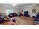 Finished basement with leather furniture and wood floors at 1461 Hada Ln, Lawrenceville, GA 30043