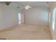 Spacious primary bedroom with carpeted floors and ceiling fan at 1461 Hada Ln, Lawrenceville, GA 30043