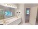 Double vanity bathroom with a large mirror and soaking tub at 1461 Hada Ln, Lawrenceville, GA 30043