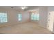 Large main bedroom with neutral walls and carpet, and multiple windows at 1461 Hada Ln, Lawrenceville, GA 30043