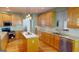 Modern kitchen with island, stainless steel appliances, and light wood cabinets at 1461 Hada Ln, Lawrenceville, GA 30043
